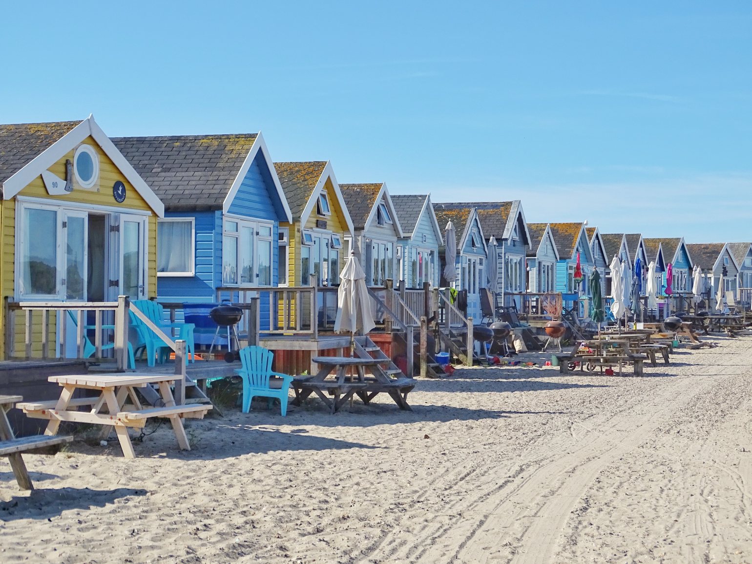 Summer Beach houses with picnic benches and barbecues