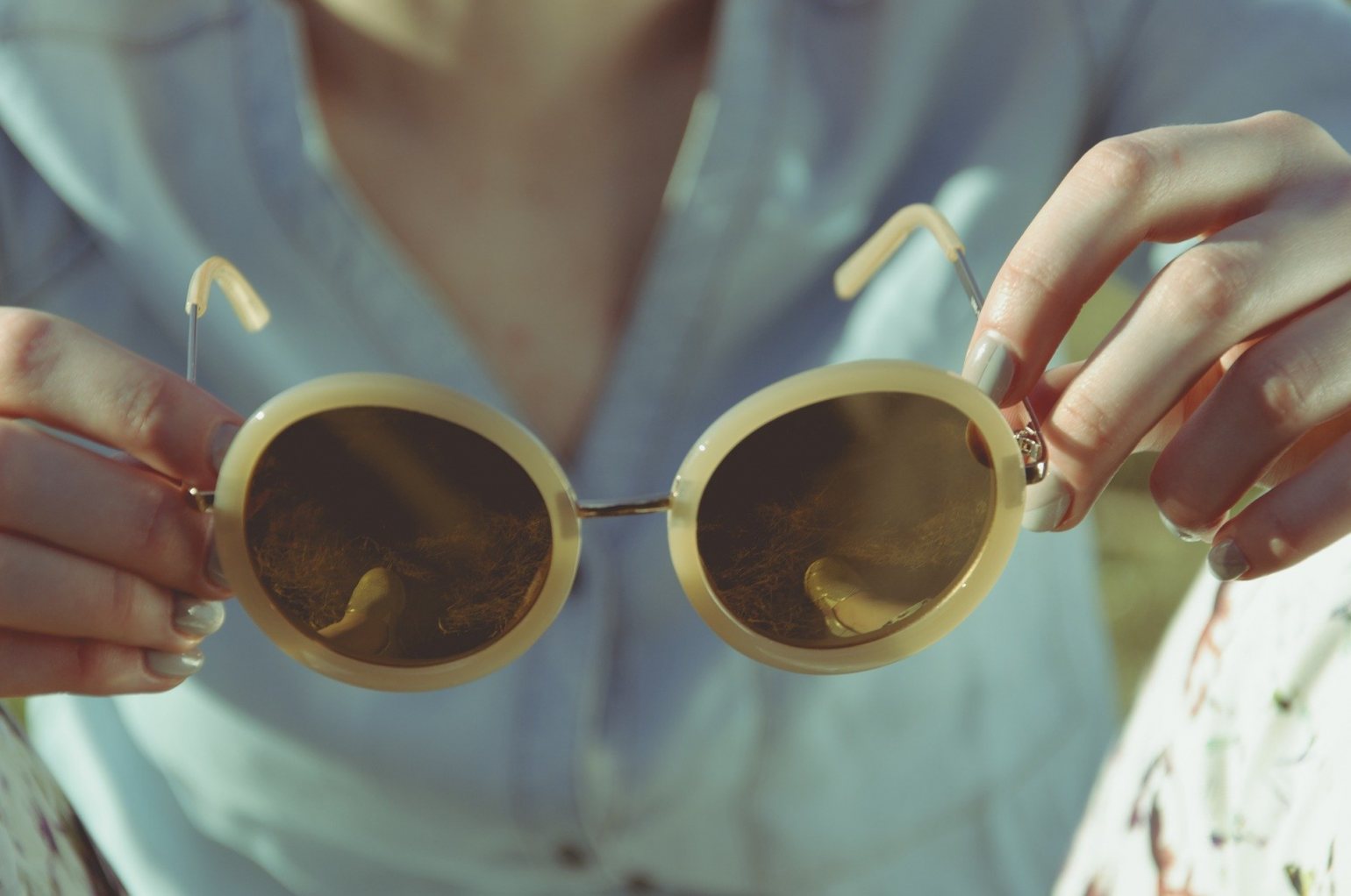 Woman holding Sunglasses