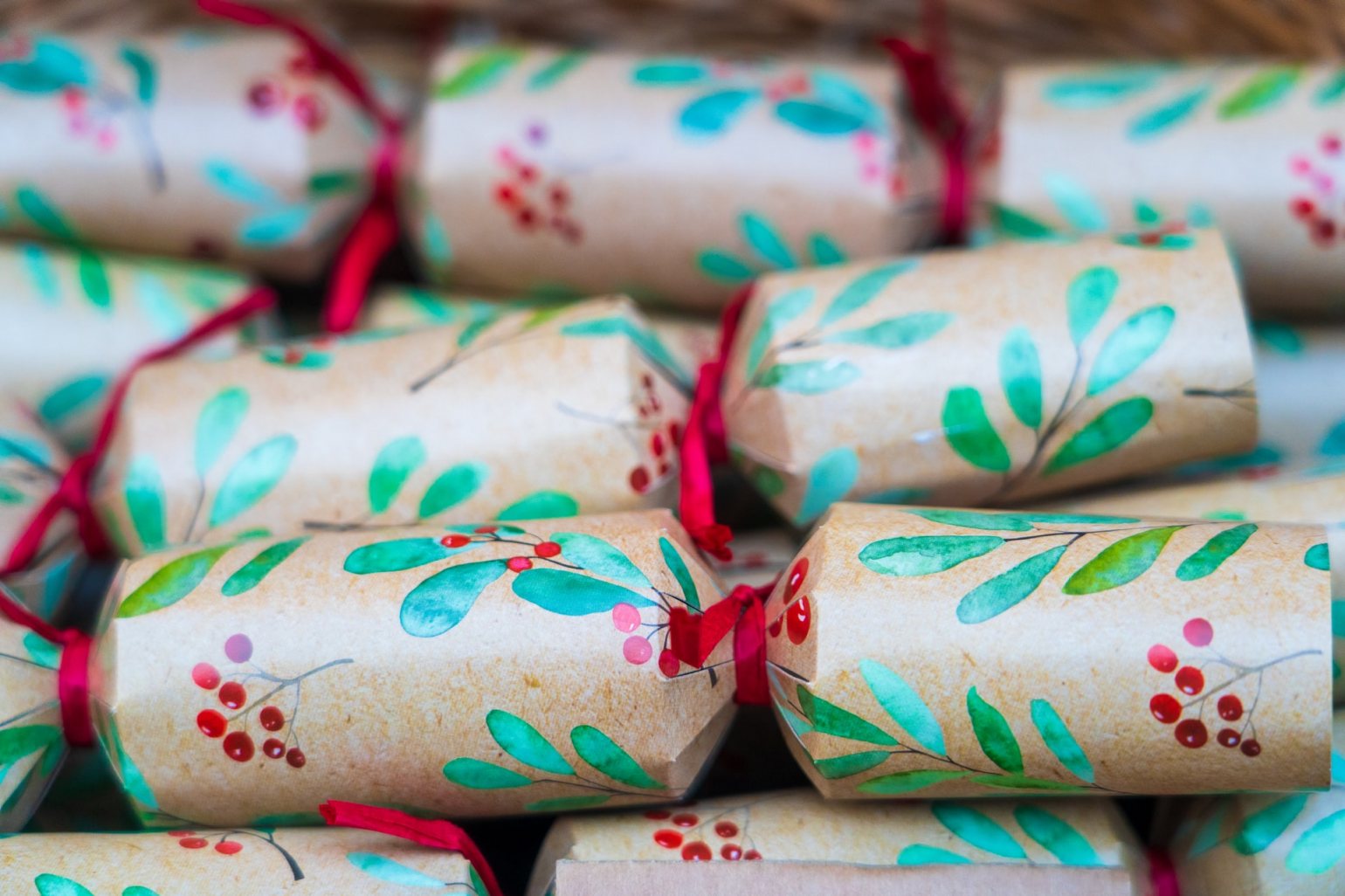 Green Christmas crackers with red ribbon