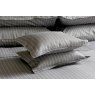Pair of Charcoal grey St. Leger pinstripe cotton pillowcases neatly arranged on bed.