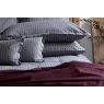 Pair of Charcoal grey St. Leger pinstripe cotton pillowcases neatly arranged on bed.