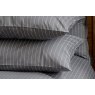 Pair of Charcoal grey St. Leger pinstripe cotton pillowcases neatly arranged on bed.