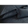 Pair of Ebony black St. Leger pinstripe cotton pillowcases neatly arranged on bed.