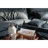 Pair of Ebony black St. Leger pinstripe cotton pillowcases neatly arranged on bed. with breakfast