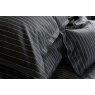 Pair of Ebony black St. Leger pinstripe cotton pillowcases neatly arranged on bed.