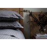 Pair of Ebony black St. Leger pinstripe cotton pillowcases neatly arranged on bed.